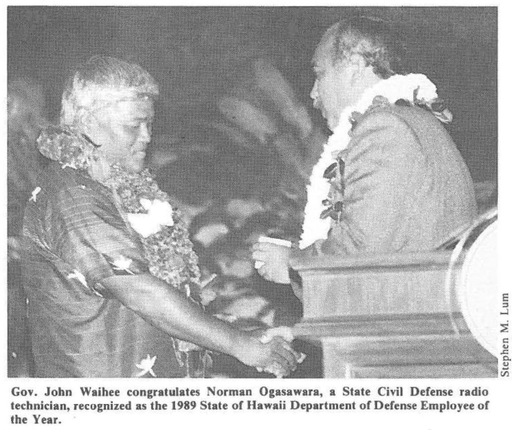 Gov. John Waihee congratulates Norman Ogasawara, a State Civil Defense radio technician, recognized as the 1989 State of Hawaii Department of Defense Employee of the Year.