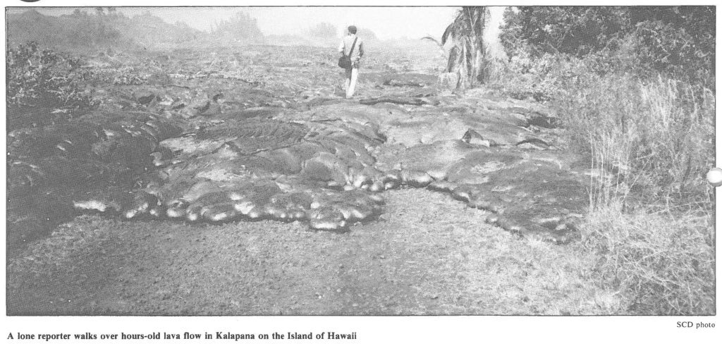 A lone reporter walks over hours-old lava flow in Kalapana on the Island of Hawaii
