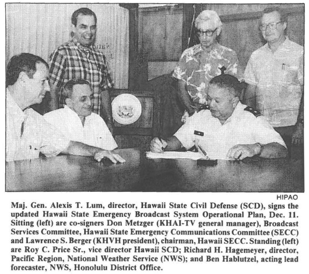 Maj. Gen. Alexis T. Lum, director, Hawaii State Civil Defense (SCD), signs the updated Hawaii State Emergency Broadcast System Operational Plan, Dec. 11. Sitting (left) are co-signers Don Metzger (KHAI-TV general manager), Broadcast Services Committee, Hawaii State Emergency Communications Committee (SECC) and Lawrence S. Berger (KHVH president), chairman, Hawaii SECC. Standing (left) are Roy C. Price Sr., vice director Hawaii SCD; Richard H. Hagemeyer, director, Pacific Region, National Weather Service (NWS); and Ben Hablutzel, acting lead forecaster, NWS, Honolulu District Office.