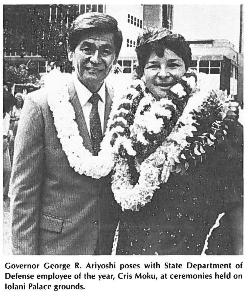 Governor George R. Ariyoshi poses with State Department of Defense employee of the year, Cris Moku, at ceremonies held on lolani Palace grounds.