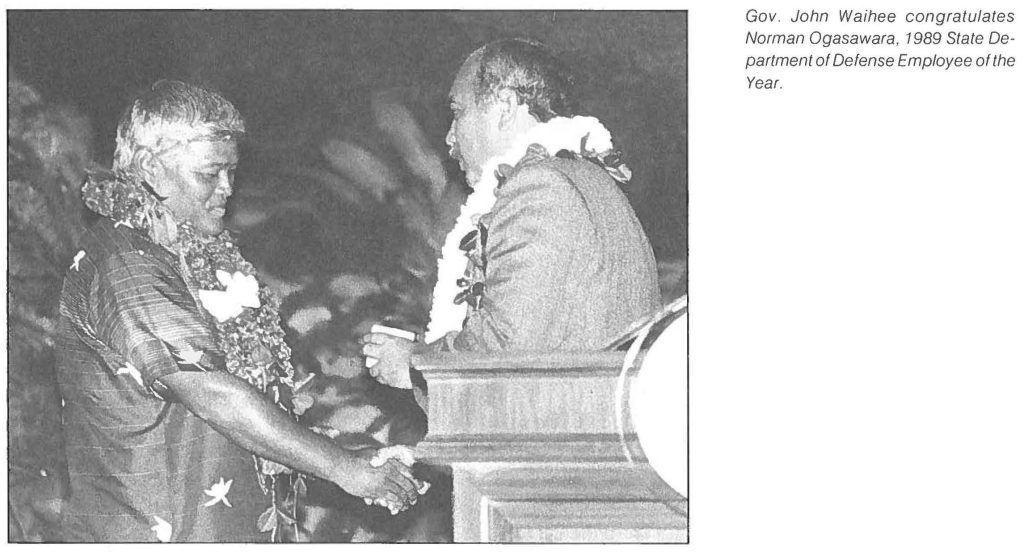 Gov. John Waihee congratulates Norman Ogasawara, 1989 State Department of Defense Employee of the Year.