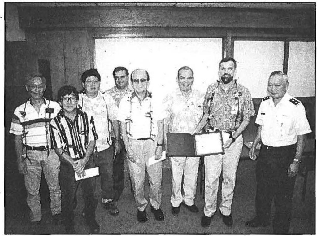 TEAM WORKERS - Tameichi Kusakabe, Leonard N. Nakashima, Howard T. Ishida, George F. Burnett, Norman M. .Ogasawara, Roy C. Price Sr. (retiring State Civil Defense vice director), Thomas C. Simon, and Maj. Gen. Edward V. Richardson, the adjutant general and director of State Civil Defense, celebrate the Emergency Satellite System Project Equipment Installation Teams award. Sgt. 1st Class Stephen M. Lum photo