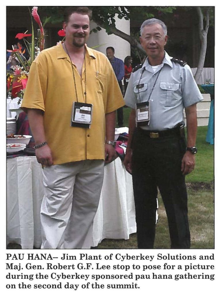 PAU HANA- Jim Plant of Cyberkey Solutions and Maj. Gen. Robert G.F. Lee stop to pose for a picture during the Cyberkey sponsored pau hana gathering on the second day of the summit.