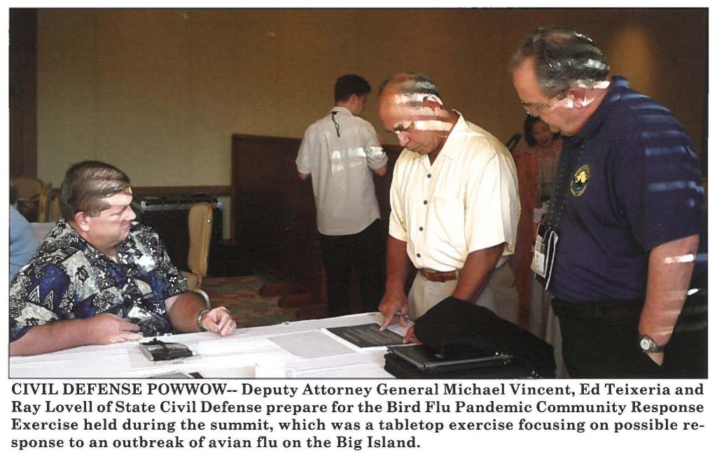 CIVIL DEFENSE POWWOW-- Deputy Attorney General Michael Vincent, Ed Teixeria and Ray Lovell of State Civil Defense prepare for the Bird Flu Pandemic Community Response Exercise held during the summit, which was a tabletop exercise focusing on possible response to an outbreak of avian flu on the Big Island.