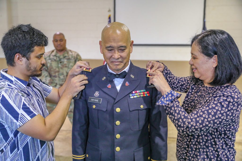 Chief Curtis Hiyane was pinned to the rank of Chief Warrant Officer 5 by his wife and son during his promotion ceremony in Pearl City on March 28, 2022. Hiyane was also selected as the new Vice Chief of Army National Guard Bands. (U.S. Army National Guard photo by Sgt. 1st Class Theresa Gualdarama)