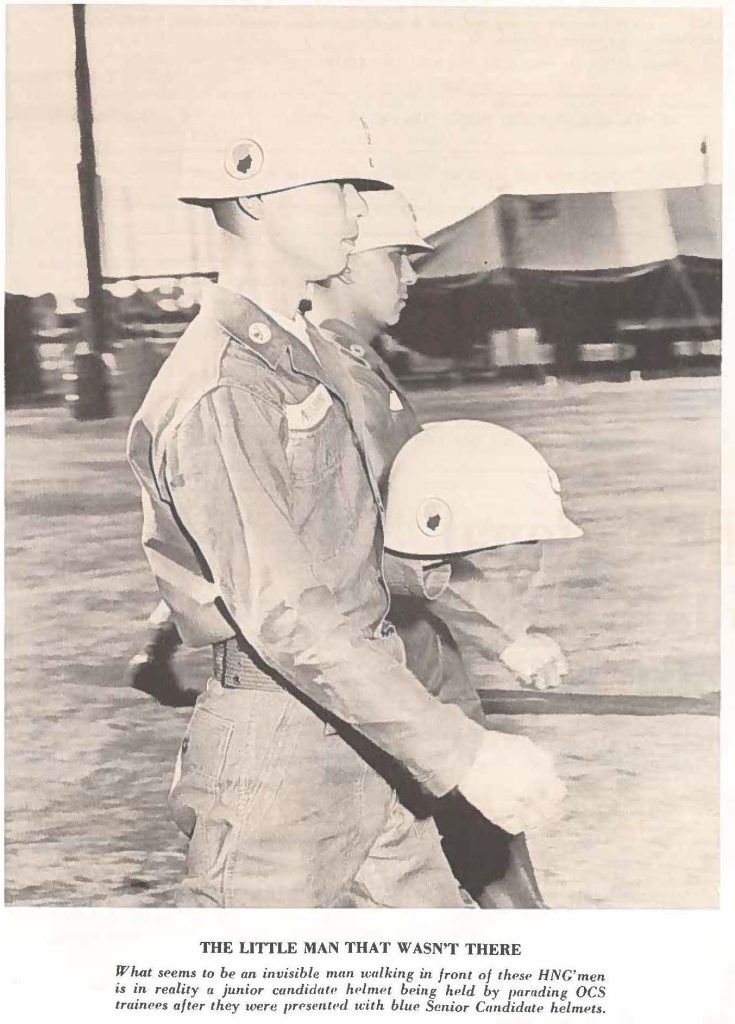 THE LITTLE MAN THAT WASN'T THERE What Seems to be an invisible man walking in front of these HNG'men is in reality a junior candidate helmet being held by parading OCS trainers after they were presented with blue Senior Candidate, helmets.