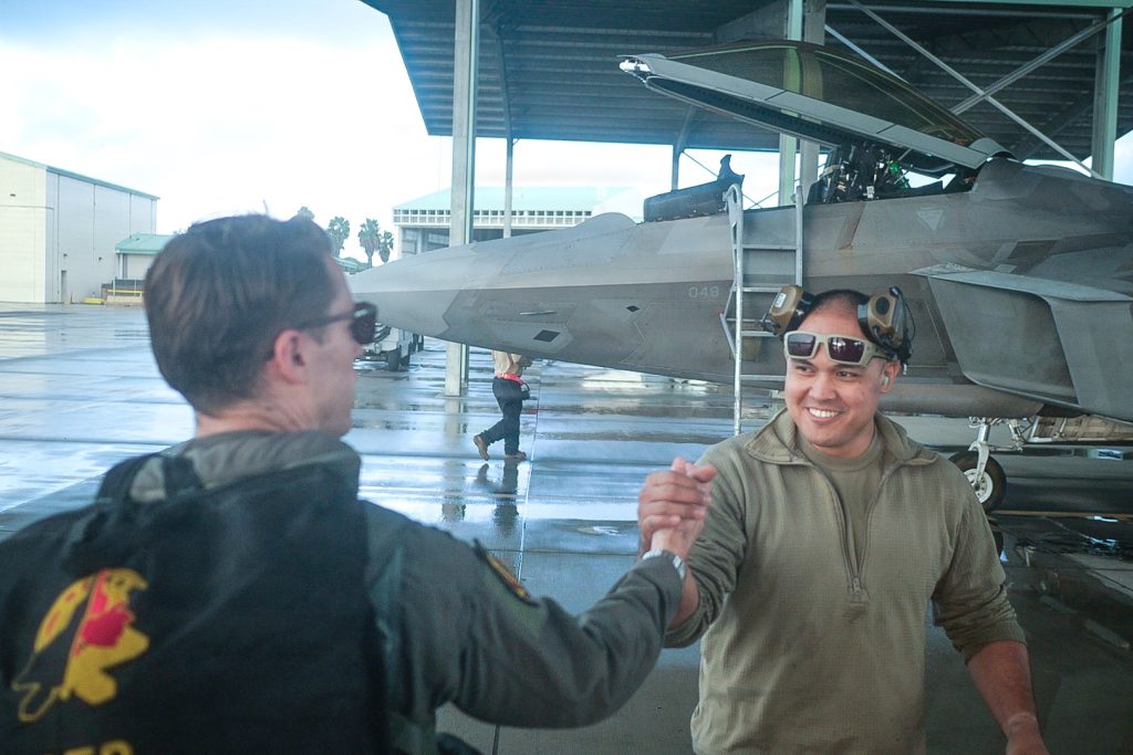 a 199th Fighter Squadron pilot greeted a crew chief during the exercise. Hosted by the 154th Wing, Sentry Aloha 26-1 highlighted the Air National Guard’s role as a fully integrated and lethal operational force within the Department of War. (U.S. Air National Guard photo by Tech. Sgt. John Linzmeier)