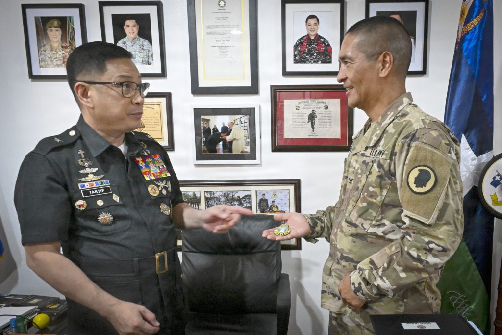Brig. Gen. Daniel Tansip, Armed Forces of the Philippines chief chaplain, received a coin from Col. Christopher Guadiz, Hawai‘i National Guard command chaplain. (U.S. Air National Guard photo by Tech. Sgt. Orlando Corpuz)