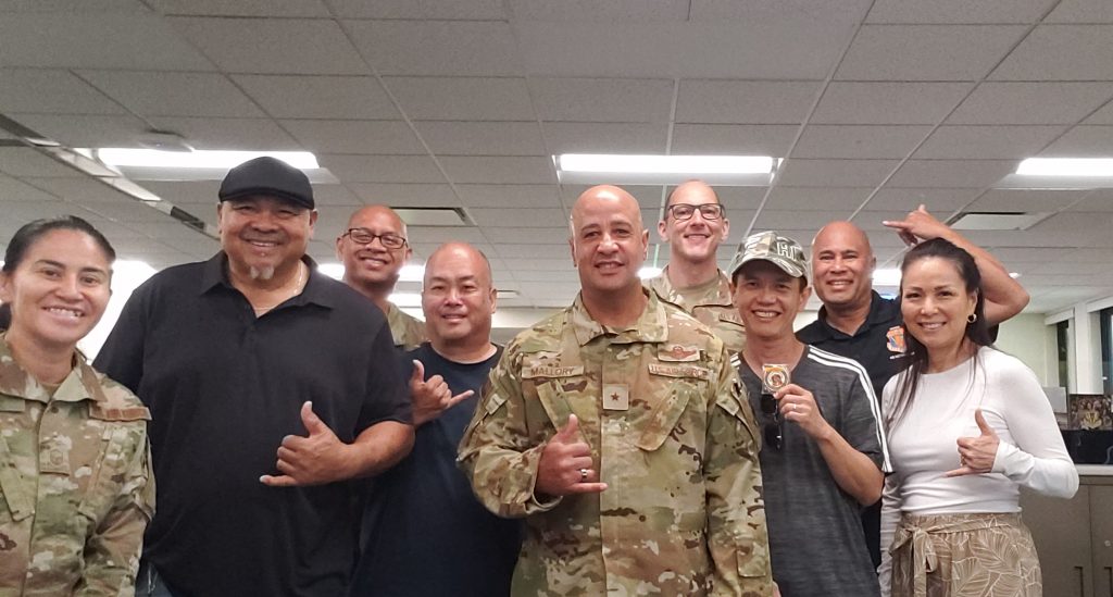 General Maintenance and Services Supervisor Patrick Tangonan, second from left, along with coin recipients Harlan Tasaka, fourth from left, and Bang Nguyen, third from right, pose with Brig. Gen. Phillip Mallory, center, and the Headquarters, Hawai‘i Air National Guard crew. U.S. Air National Guard photos by retired Master Sgt. Darrell Bactad