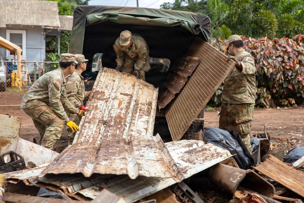Guardsmen loaded flood debris onto vechicles on March 28. (U.S. Army National Guard photo by Spc. Donald Bond)