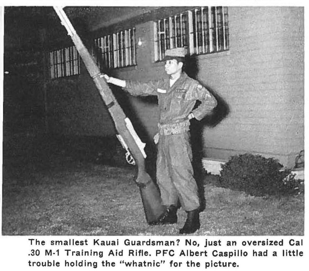 The smallest Kauai Guardsman? No, just an oversized Cal .30 M-1 Training Aid Rifle. PFC Albert Caspillo had a little trouble holding the "whatnic" for the picture.