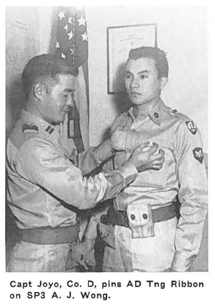 Capt Joyo, Co. O, pins AO Tng Ribbon on SP3 A. J. Wong.
