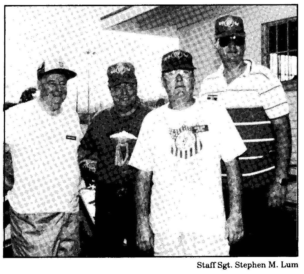 (Below) When Hurricane Iniki swept away their 50th anniversary celebration plans, World War II veterans Michael Sheehan,Victor Olney, Michael Guiry, and Joseph Rourke, of the "Fighting" 69th Infantry, stepped in to help with National Guard relief efforts by cooking and serving food to hurricane victims.
