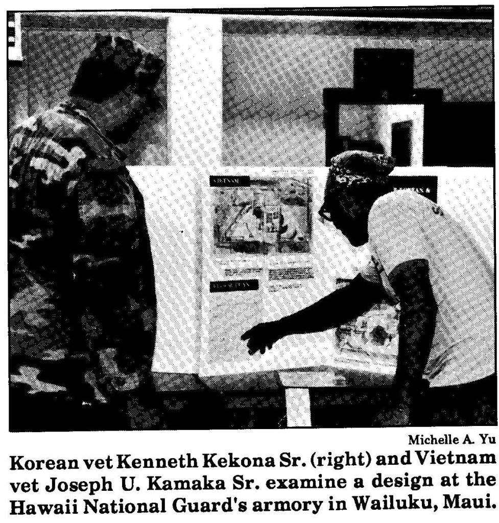 Korean vet Kenneth Kekona Sr. (right) and Vietnam vet Joseph U. Kamaka Sr. examine a design at the Hawaii National Guard's armory in Wailuku, Maui.