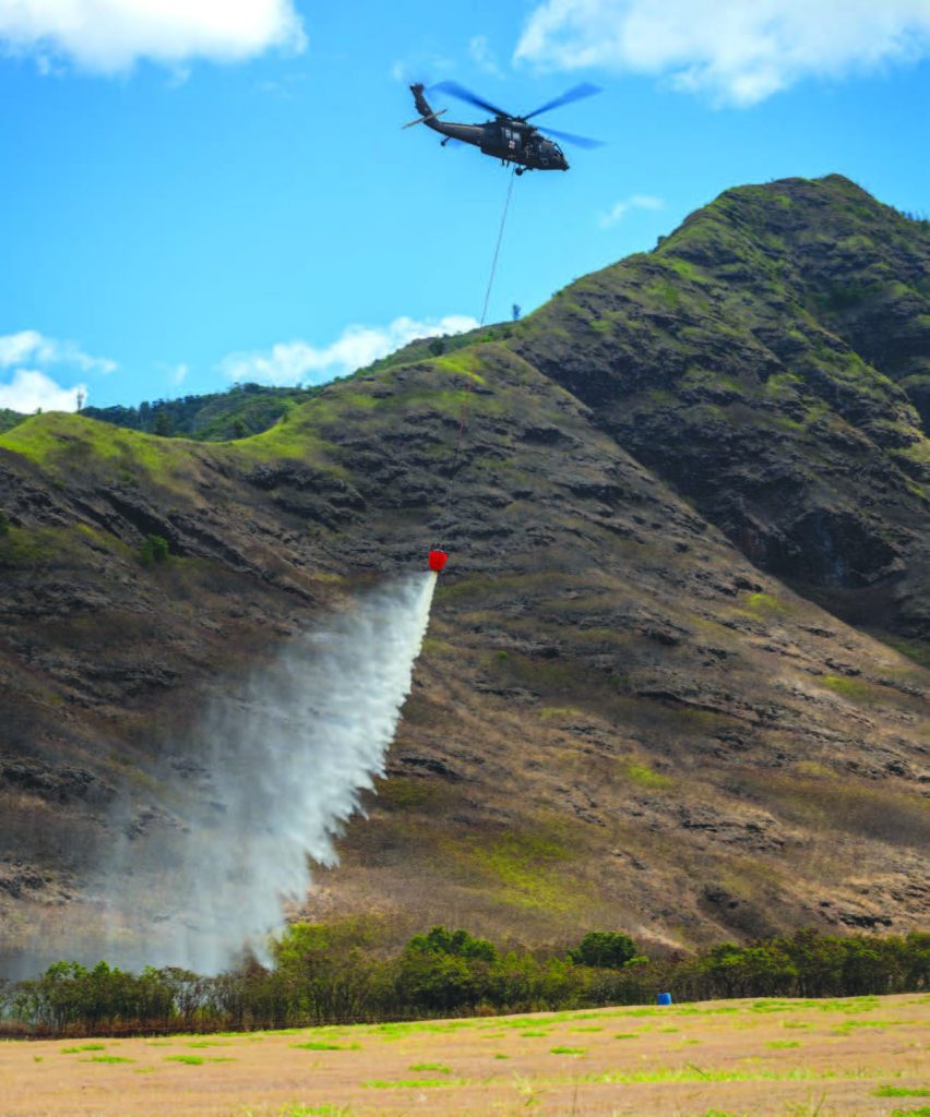 A UH-60 Black Hawk performed a water bucket flight demonstration in Makua Valley on Sept. 5, 2024. The exercise took place during a weeklong Rotary Wing Aviation subject matter expert exchange as part of the State Partnership Program. – Hawai‘i National Guard photo by Master Sgt. Mysti Bicoy
