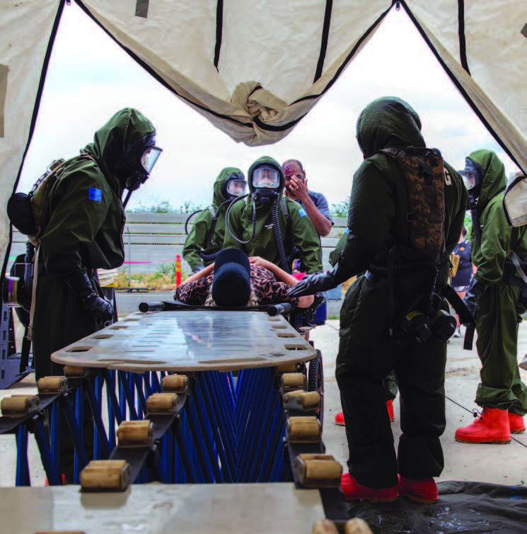 The 93rd Chemical, Biological, Radiological/Nuclear (CBRN) Enhanced Response Force Package moved patients towards the decontamination lanes during their CBRN culminating training event in Kalaeloa, in August 2024. This joint training event included members from Nevada and California National Guard. – Hawai‘i National Guard photo by Spc. Sean Walker