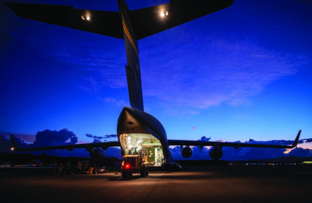 Airmen from the 15th and Hawai‘i Air National Guard, unloaded equipment from a U.S. Air Force C-17 Globemaster III during the Joint Pacific Multinational Readiness Center (JPMRC) exercise at Kahului Airport on Maui in October 2024. The JPMRC is the Army’s newest Combat Training Center and generates readiness in the environments and conditions where our forces are most likely to operate in JPMRC. – Hawai‘i National Guard photo by Master Sgt. Mysti Bicoy