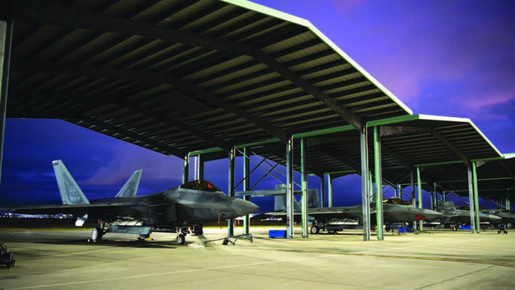 F-22 Raptors assigned to the 154th Wing were parked beneath aircraft aprons at Joint Base Pearl Harbor-Hickam in December 2024. The 199th Fighter Squadron serves as the active associate in its partnership with the 19th Fighter Squadron, where both units share the responsibility of operating the Raptors. – Hawai‘i National Guard photo by Tech. Sgt. John Linzmeier