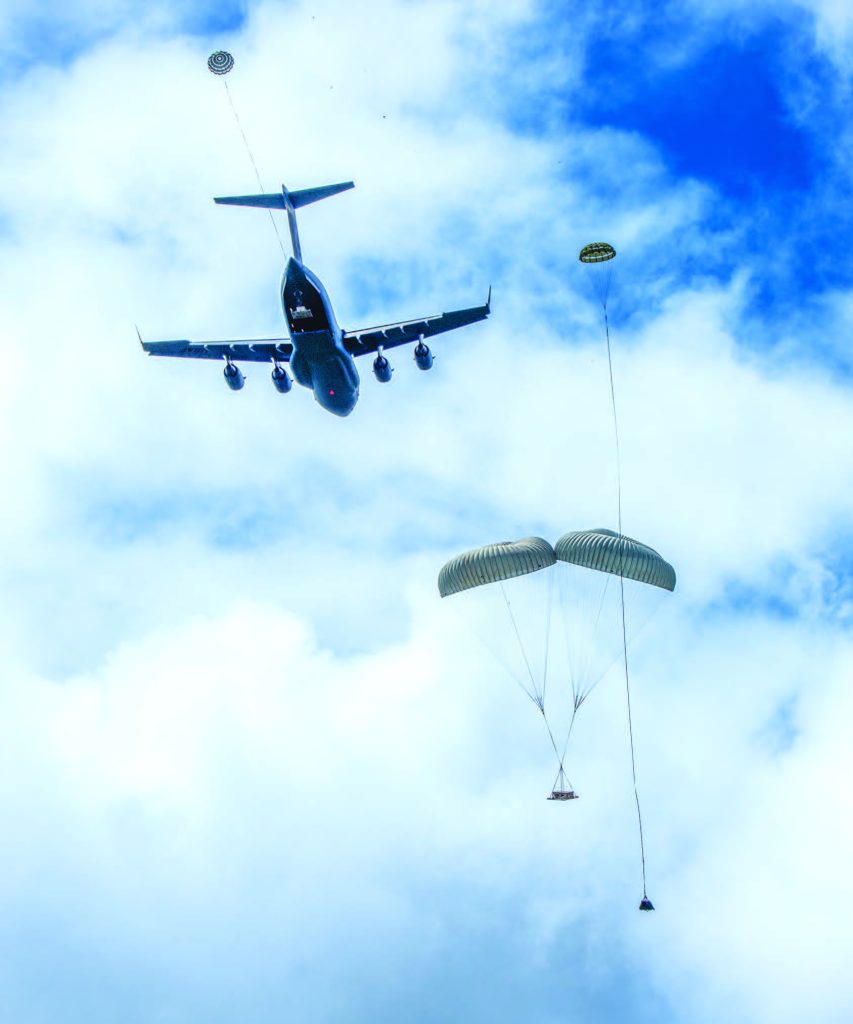 A U.S. Air Force C-17 Globemaster III with a crew from the 204th Airlift Squadron, conducted total force integrated unilateral airdrops at the Kahikina Range on O‘ahu in July 2024. The simulated munition and cargo air drop training is conducted to provide proficiency and currency, enhancing the capabilities of aircrew and support personnel in precision airdrop operations. – Hawai‘i National Guard photo by Master Sgt. Mysti Bicoy
