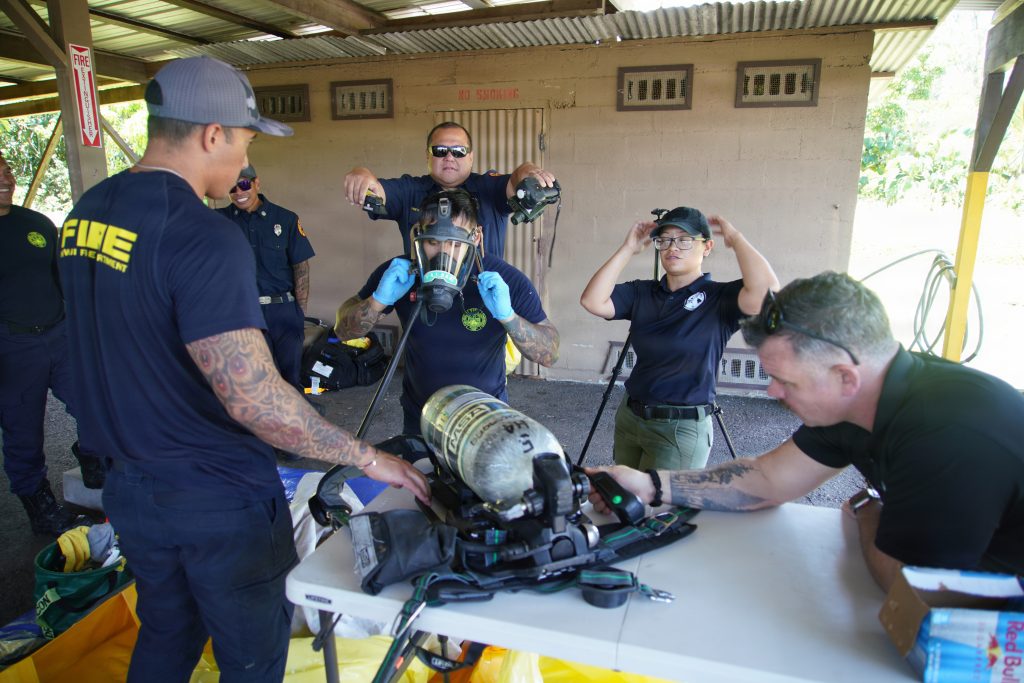 Above, Sgt. Kaialani Cruz, second from right, of the Hawaiʻi National Guard 93rd Civil Support Team (93rd CST), briefed members of the Hawaiʻi Island Fire Department in June on the decontamination process after entering a chemical, biological or nuclear explosive scene. (U.S. National Guard photos by retired Master Sgt. Andrew Lee Jackson)