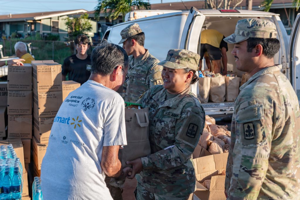 U.S. Army Spc. Taylor Calixterio-Martinez handed groceries to a volunteer. (U.S. Army National Guard photos by Staff Sgt. John Schoebel)