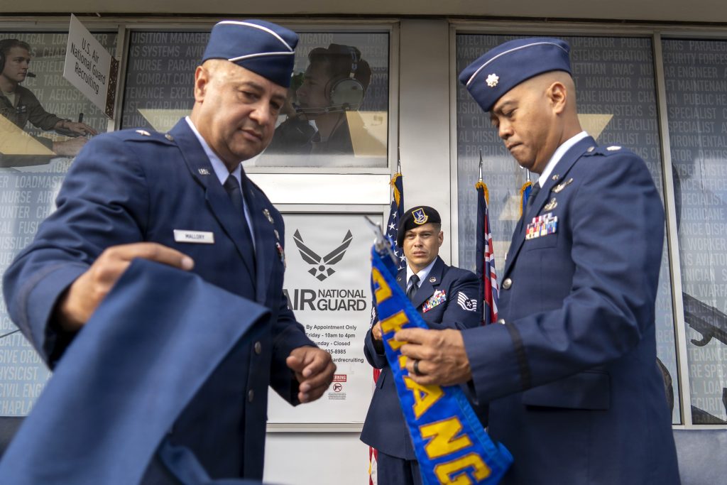 Brig. Gen. Phillip Mallory, Hawai‘i Air National Guard commander and Lt. Col. Michael Buendia, Headquarters Hawaii Air National Guard Recruiting Flight commander, unfurled the Headquarters Hawai‘i Air National Guard Recruiting and Retention Flight guidon during the unit’s activation ceremony held at Pearl Highlands Center in Pearl City on Aug. 1. (U.S. Air National Guard photo by Tech. Sgt. Orlando Corpuz)