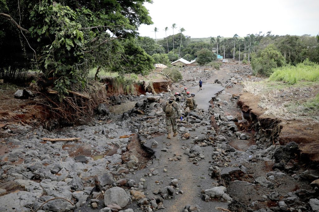 The Hawai‘i National Guard’s 93rd Chemical, Biological, Radiological, Nuclear and Explosives Enhanced Response Force Package team walked over a damaged road to conduct area searches and wellness checks in the Ka‘ū District on Hawai‘i Island on Aug. 19 following impacts by Hurricane Lala. (U.S. Army National Guard photo by Spc. Daniel Barcenas)