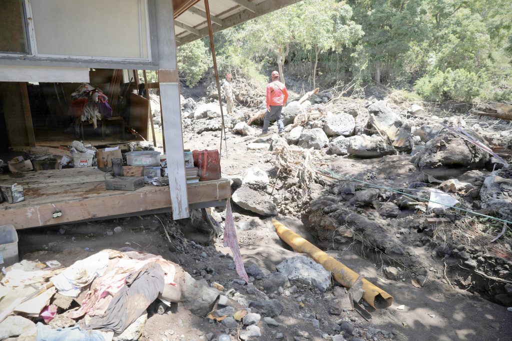 A Guardsman assessed damage in the Ka‘ū District on the Big Island alongside a Hawai‘i Fire Department member on August 20. (U.S Army National Guard photos by Spc. Daniel Barcenas)